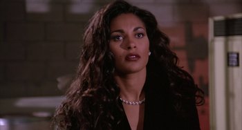 Movie still from “A Low Down Dirty Shame” (1994), directed by Keenen Ivory Wayans – A person with long hair wearing a necklace; Close Up shot, High angle