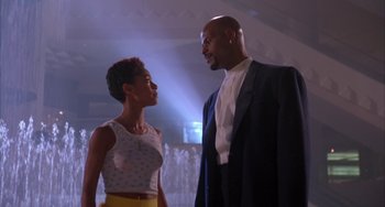 Movie still from “A Low Down Dirty Shame” (1994), directed by Keenen Ivory Wayans – A man and a woman standing next to each other; Medium shot, Low angle