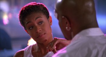 Movie still from “A Low Down Dirty Shame” (1994), directed by Keenen Ivory Wayans – A woman looking at a man with his hand on her shoulder; Close Up shot, Over the shoulder angle
