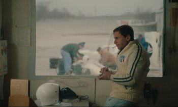 Movie still from “A Man and a Woman” (1966), directed by Claude Lelouch – A man standing in front of a window holding a wii controller; Medium shot, Over the shoulder angle