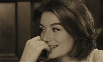Movie still from “A Man and a Woman” (1966), directed by Claude Lelouch – A person with her hand on her face; Close Up shot, High angle