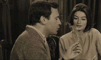 Movie still from “A Man and a Woman” (1966), directed by Claude Lelouch – A man and a woman are talking to each other; Close Up shot, High angle