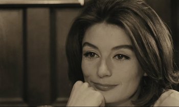 Movie still from “A Man and a Woman” (1966), directed by Claude Lelouch – A person with her hand under her chin; Close Up shot, High angle