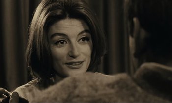Movie still from “A Man and a Woman” (1966), directed by Claude Lelouch – A person sitting in front of a mirror; Close Up shot, Over the shoulder angle