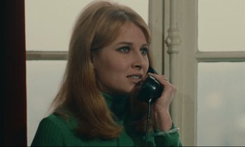 Movie still from “A Man and a Woman” (1966), directed by Claude Lelouch – A woman talking on a phone while wearing a green shirt; Close Up shot, Low angle