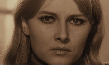 Movie still from “A Man and a Woman” (1966), directed by Claude Lelouch – A woman's face in sepia tones; Extreme Close Up shot, Low angle
