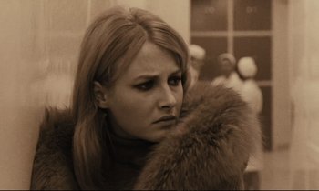 Movie still from “A Man and a Woman” (1966), directed by Claude Lelouch – A woman in a fur coat is looking at the camera; Close Up shot, Over the shoulder angle
