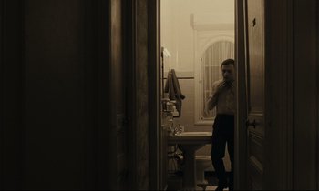 Movie still from “A Man and a Woman” (1966), directed by Claude Lelouch – A man taking a picture of himself in the mirror; Medium shot, Low angle