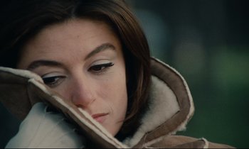 Movie still from “A Man and a Woman” (1966), directed by Claude Lelouch – A person wearing a jacket; Close Up shot, High angle