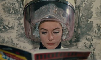 Movie still from “A Man and a Woman” (1966), directed by Claude Lelouch – A woman with a hair dryer on top of her head; Close Up shot, High angle