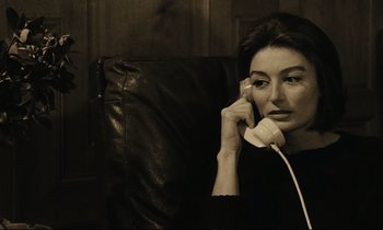 Movie still from “A Man and a Woman” (1966), directed by Claude Lelouch – A woman sitting in a chair talking on a phone; Close Up shot, High angle