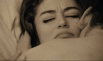 Movie still from “A Man and a Woman” (1966), directed by Claude Lelouch – A person laying on a bed; Close Up shot, Overhead angle