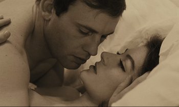 Movie still from “A Man and a Woman” (1966), directed by Claude Lelouch – A man and a woman laying in a bed; Close Up shot, Overhead angle