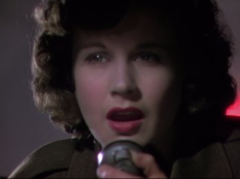 Movie still from “A Matter of Life and Death” (1946), directed by Emeric Pressburger – A woman in a fur hat is holding a microphone; Close Up shot, Low angle