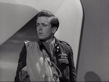 Movie still from “A Matter of Life and Death” (1946), directed by Emeric Pressburger – A man in a military uniform standing in front of a wall; Close Up shot, Low angle