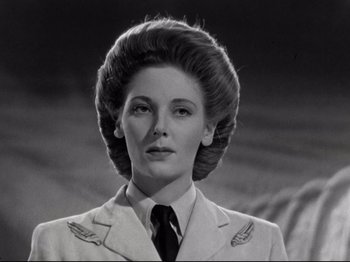 Movie still from “A Matter of Life and Death” (1946), directed by Emeric Pressburger – A woman in a military uniform is looking at the camera; Close Up shot, Low angle