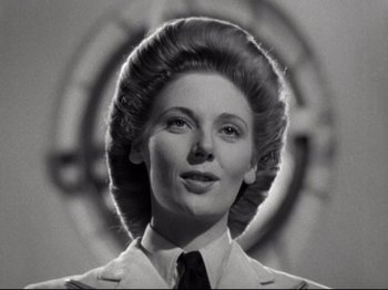 Movie still from “A Matter of Life and Death” (1946), directed by Emeric Pressburger – An old photo of a woman in a suit and tie; Close Up shot, Low angle