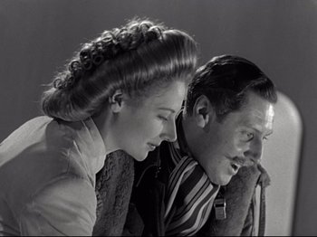 Movie still from “A Matter of Life and Death” (1946), directed by Emeric Pressburger – An older man and a young woman looking at each other; Close Up shot, Low angle