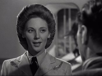 Movie still from “A Matter of Life and Death” (1946), directed by Emeric Pressburger – A black and white photo of a woman in a military uniform; Close Up shot, Low angle