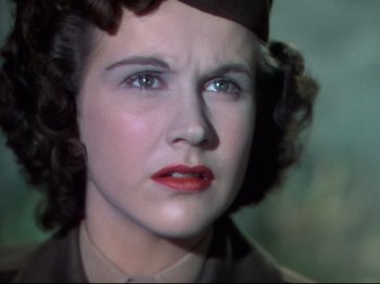 Movie still from “A Matter of Life and Death” (1946), directed by Emeric Pressburger – A woman's face in a military uniform; Close Up shot, Low angle