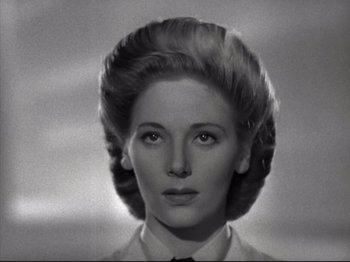 Movie still from “A Matter of Life and Death” (1946), directed by Emeric Pressburger – A black and white photo of a woman with a black tie; Close Up shot, Low angle