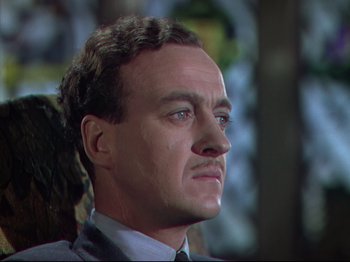 Movie still from “A Matter of Life and Death” (1946), directed by Emeric Pressburger – A man with a beard and a suit and tie looking to his left; Close Up shot, Low angle