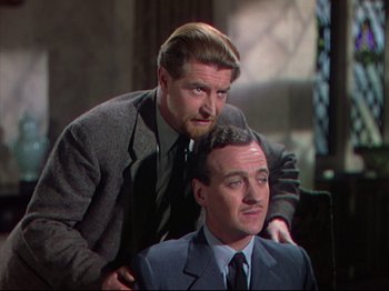 Movie still from “A Matter of Life and Death” (1946), directed by Emeric Pressburger – Two men in business suits are sitting in a chair; Medium shot, Over the shoulder angle