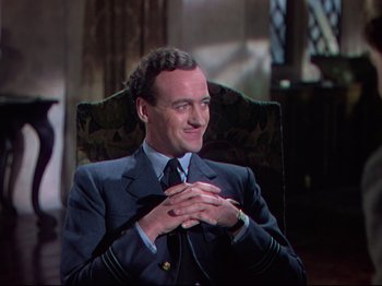 Movie still from “A Matter of Life and Death” (1946), directed by Emeric Pressburger – A man in a suit sitting in a chair; Medium shot, Over the shoulder angle