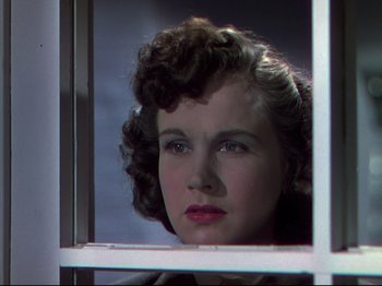 Movie still from “A Matter of Life and Death” (1946), directed by Emeric Pressburger – A woman with curly hair looking out of a window; Close Up shot, Low angle