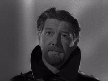 Movie still from “A Matter of Life and Death” (1946), directed by Emeric Pressburger – A man with a beard is looking at the camera; Close Up shot, Low angle