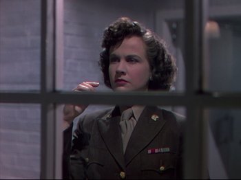 Movie still from “A Matter of Life and Death” (1946), directed by Emeric Pressburger – A woman in uniform looking out of a window; Close Up shot, Low angle