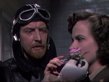 Movie still from “A Matter of Life and Death” (1946), directed by Emeric Pressburger – A man and a woman holding a rose in their hands; Close Up shot, Over the shoulder angle