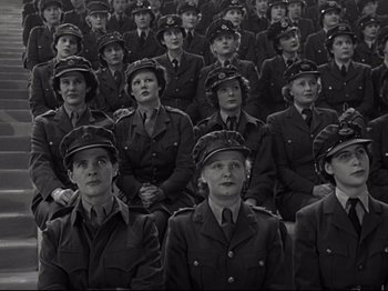 Movie still from “A Matter of Life and Death” (1946), directed by Emeric Pressburger – A black and white photo of a group of women in uniform; Medium shot, High angle