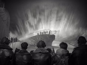 Movie still from “A Matter of Life and Death” (1946), directed by Emeric Pressburger – A group of people standing in front of a waterfall; Extreme Wide shot, High angle