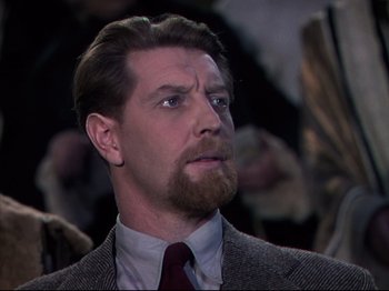 Movie still from “A Matter of Life and Death” (1946), directed by Emeric Pressburger – A person wearing a suit and tie; Close Up shot, Over the shoulder angle