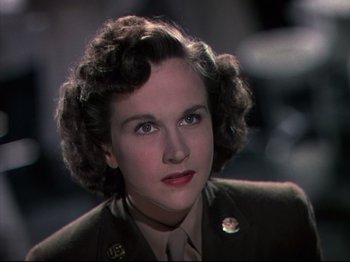 Movie still from “A Matter of Life and Death” (1946), directed by Emeric Pressburger – A woman in a military uniform is looking at the camera; Close Up shot, Low angle