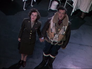 Movie still from “A Matter of Life and Death” (1946), directed by Emeric Pressburger – A man and a woman dressed in military uniforms; Medium shot, Low angle