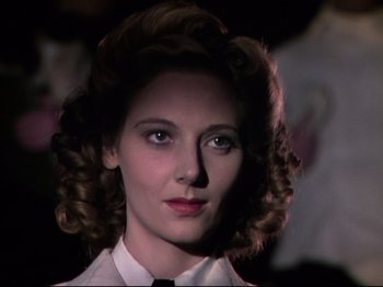 Movie still from “A Matter of Life and Death” (1946), directed by Emeric Pressburger – A person with curly hair wearing a tie; Close Up shot, Low angle