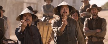 Movie still from “A Million Ways to Die in the West” (2014), directed by Seth MacFarlane – A man with a hat and a mustache on his head; Medium shot, Over the shoulder angle