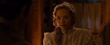 Movie still from “A Million Ways to Die in the West” (2014), directed by Seth MacFarlane – A woman in a white dress and a white hat; Close Up shot, Over the shoulder angle