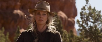 Movie still from “A Million Ways to Die in the West” (2014), directed by Seth MacFarlane – A woman in a hat and a jacket in the desert; Close Up shot, Over the shoulder angle