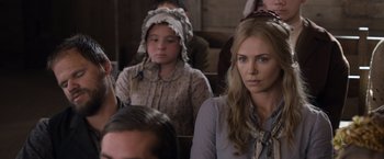 Movie still from “A Million Ways to Die in the West” (2014), directed by Seth MacFarlane – A woman in a blue shirt and a girl in a pink dress; Close Up shot, Over the shoulder angle