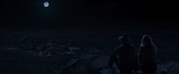 Movie still from “A Million Ways to Die in the West” (2014), directed by Seth MacFarlane – A man standing on top of a hill at night; Extreme Wide shot, Low angle