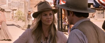 Movie still from “A Million Ways to Die in the West” (2014), directed by Seth MacFarlane – A woman wearing a brown hat and a man wearing a brown hat; Close Up shot, Over the shoulder angle