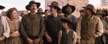 Movie still from “A Million Ways to Die in the West” (2014), directed by Seth MacFarlane – A group of men in old time clothing standing next to each other; Medium shot, Over the shoulder angle