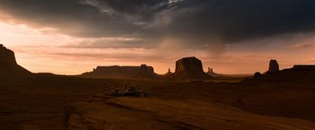 Movie still from “A Million Ways to Die in the West” (2014), directed by Seth MacFarlane – A view of a desert landscape at sunset; Extreme Wide shot, High angle