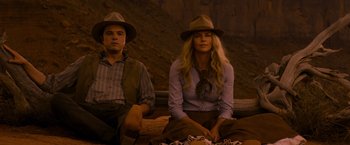 Movie still from “A Million Ways to Die in the West” (2014), directed by Seth MacFarlane – A man and a woman sitting next to each other; Medium shot, Over the shoulder angle