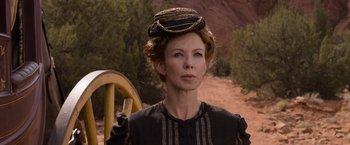 Movie still from “A Million Ways to Die in the West” (2014), directed by Seth MacFarlane – A woman with a hat on her head standing on a dirt road; Close Up shot, Low angle