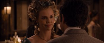 Movie still from “A Million Ways to Die in the West” (2014), directed by Seth MacFarlane – A beautiful woman with long blonde hair wearing a green dress; Close Up shot, Over the shoulder angle