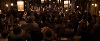 Movie still from “A Million Ways to Die in the West” (2014), directed by Seth MacFarlane – A group of people in a room with hats on; Wide shot, High angle
